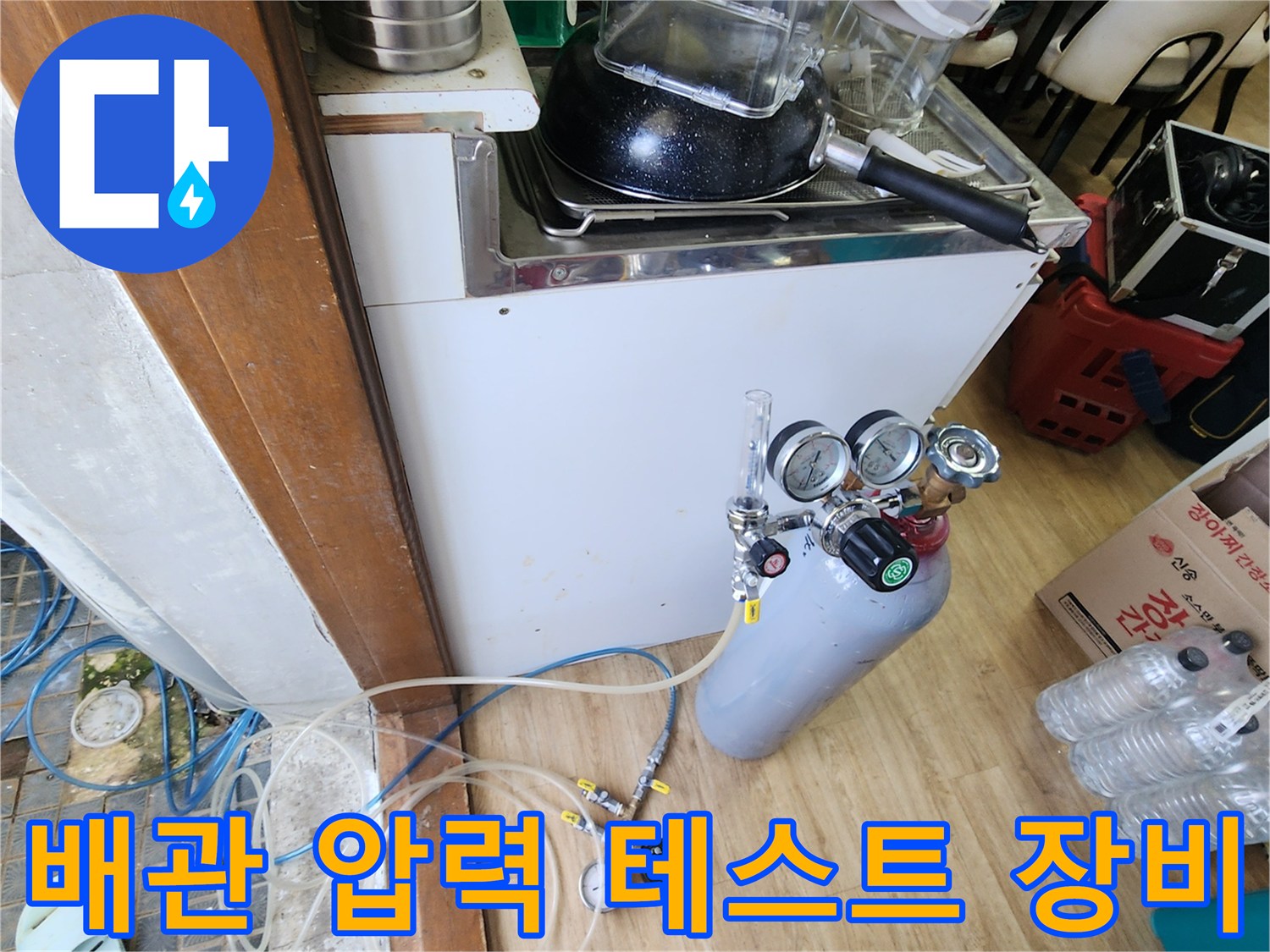 누수 지점 확인을 위해 사용 중인 공압 테스트 장치와 가스 탐지용 탱크