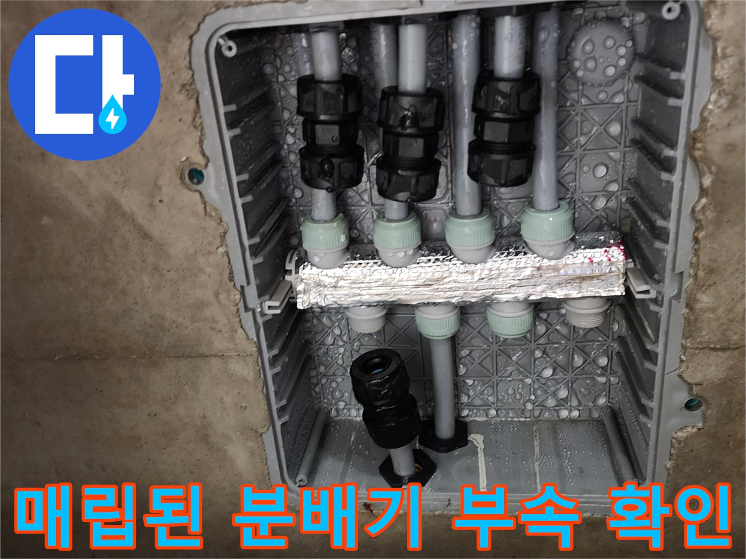 배관 연결 소켓과 검은색 밸브 부위가 보이는 매립함 내부 사진입니다.