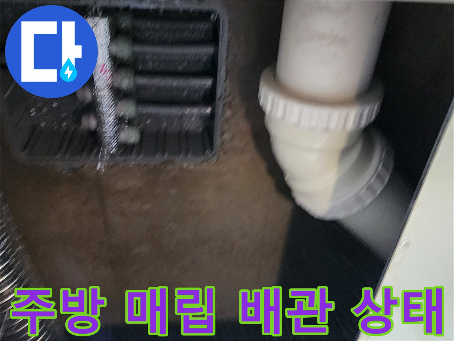 싱크대 아래쪽 매립 공간 내 분배기와 하수 배관 상세 모습
