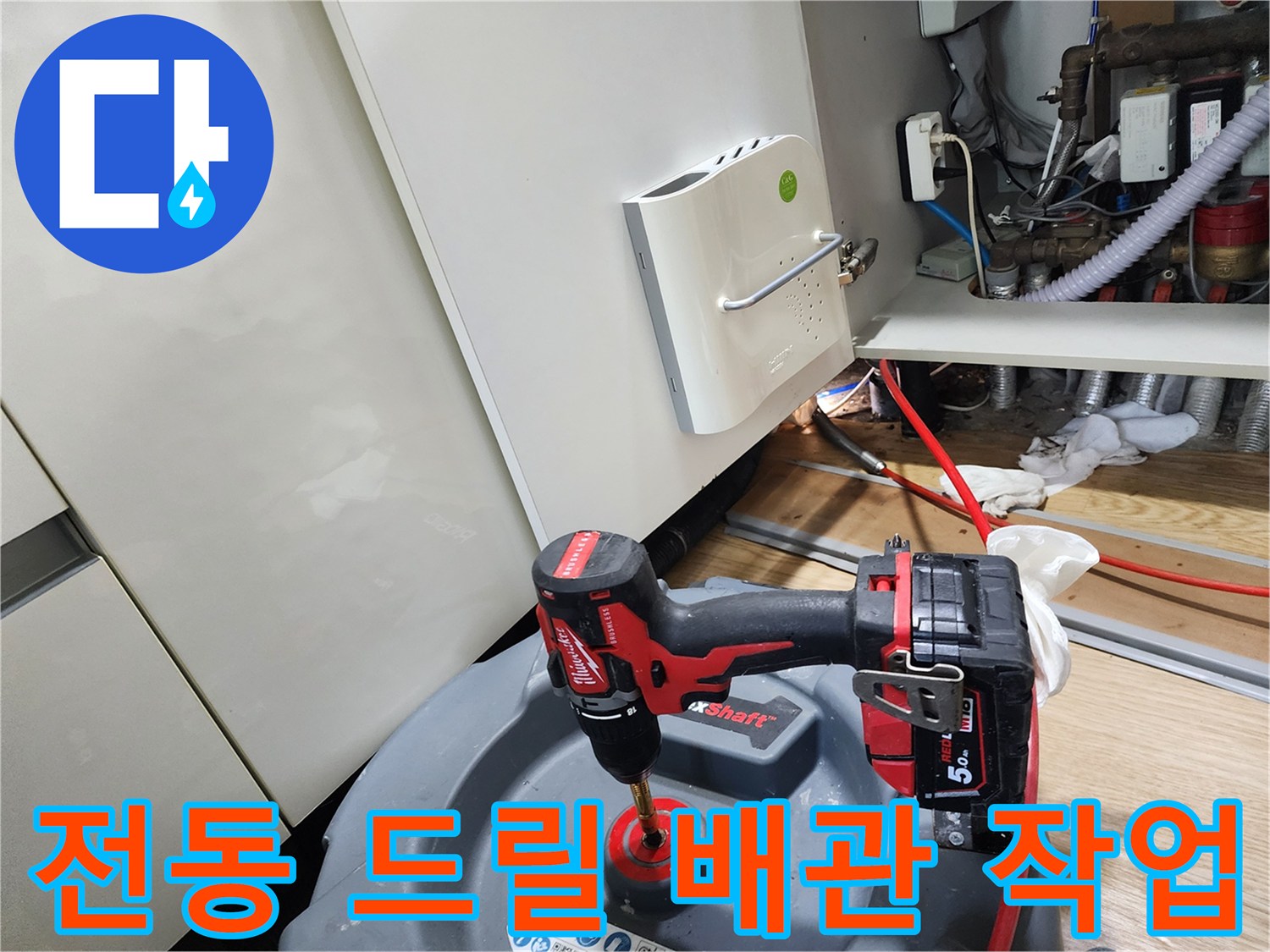 싱크대 하부 배관 보수를 위해 전동 공구를 사용하는 엔지니어의 모습
