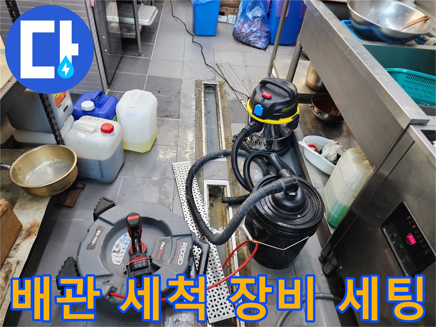 식당 주방 트렌치 - 배수구 막힘 해결을 위해 준비된 습식 청소기와 작업 도구들