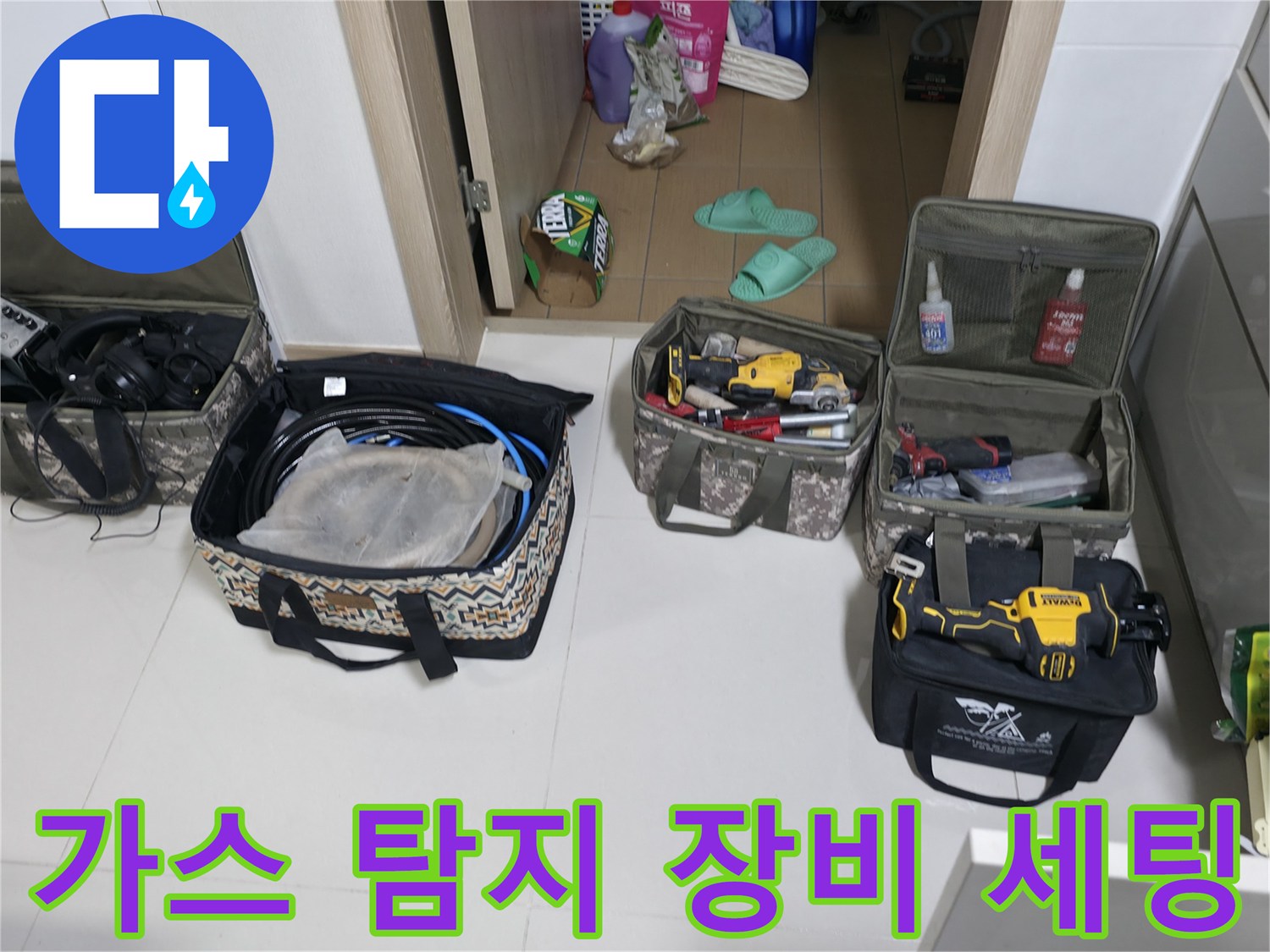 바닥에 펼쳐진 가스 탐지기와 각종 배관 점검용 전문 공구들입니다.