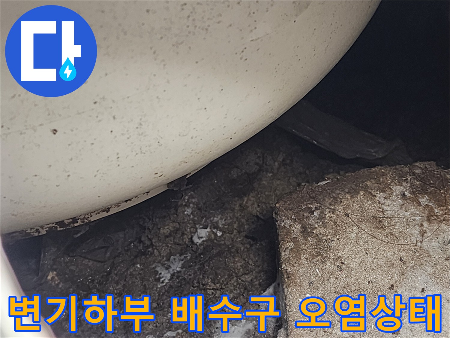 변기 아래쪽 배수구 주변에 이물질과 오염이 심한 상태를 보여주는 사진입니다.