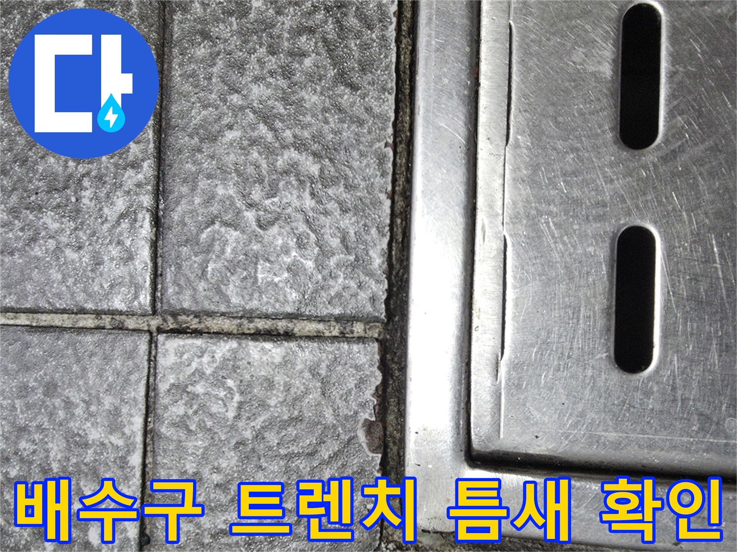 벌어진 타일 틈새와 스테인리스 배수 트렌치 부위