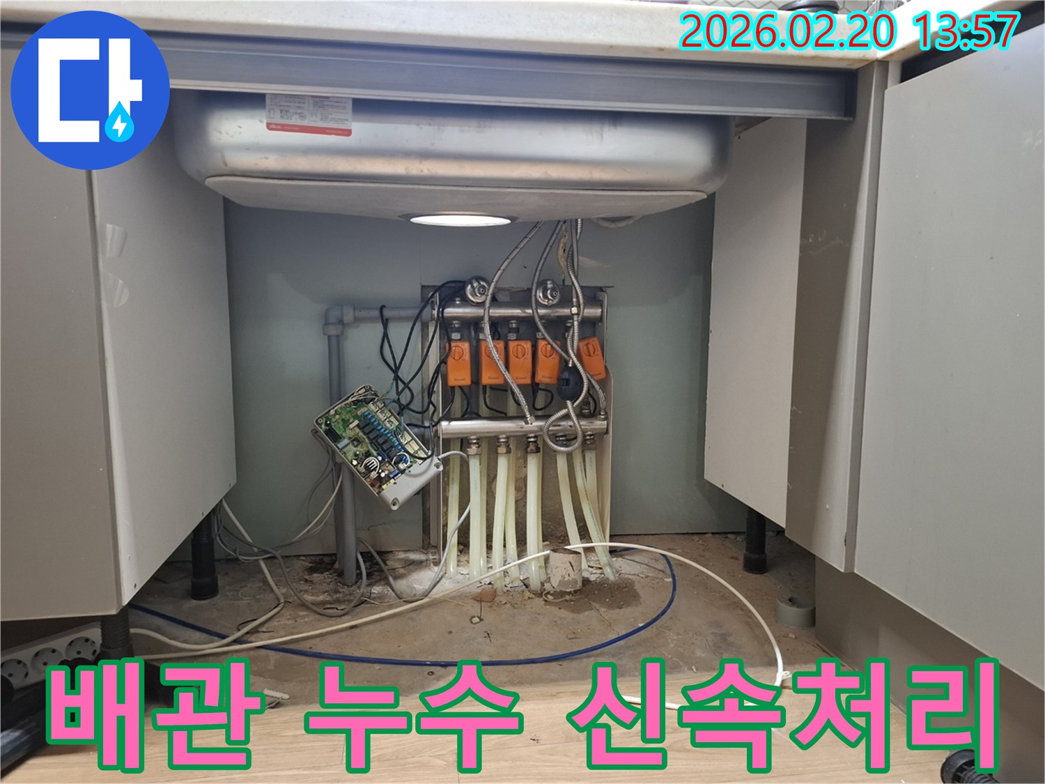 싱크대 하부의 복잡한 배관에서-누수가 발생하여-전문 엔지니어가 신속하게 방문하여-문제를 해결하고 있습니다