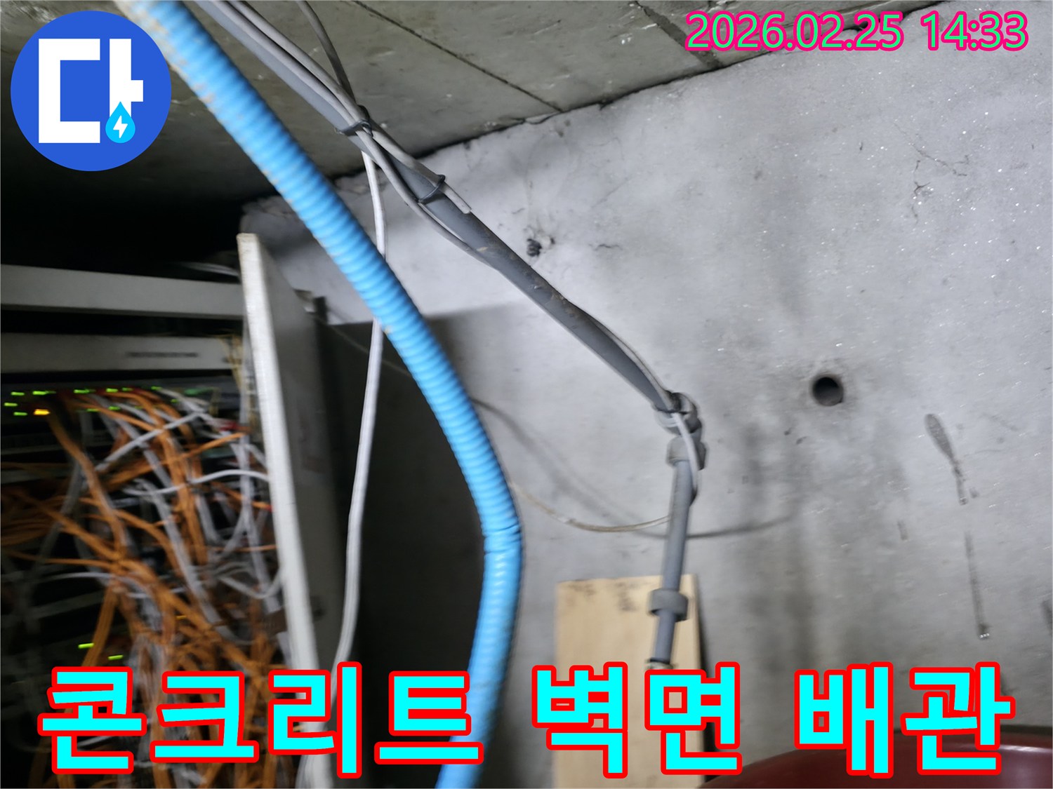 콘크리트 벽면에 고정된-파란색 주름관과 회색 케이블들이-누수 탐지 작업의-중요한 단서가 될 수 있습니다