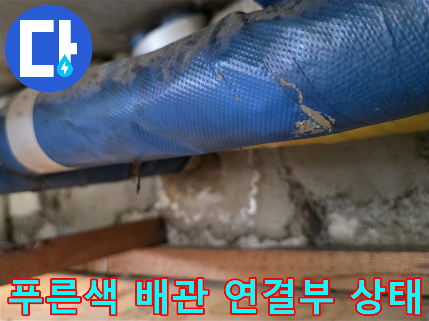 아파트 천장 점검구 내부-푸른색 보온재로 감싸진 배관과 노출된 연결 부위
