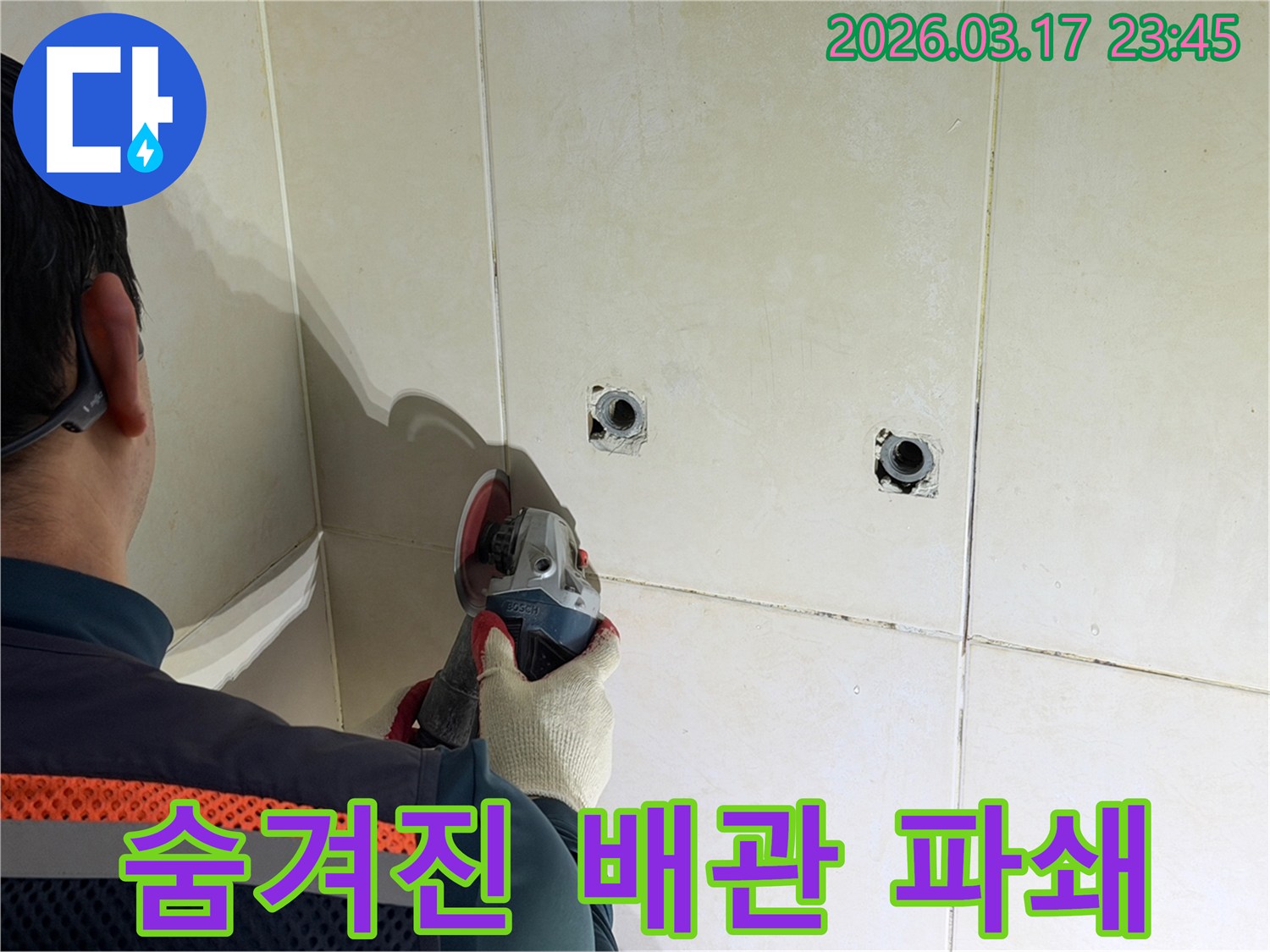 누수공사 현장에서-엔지니어가-숨겨진 배관 확인을 위해-벽면 타일을-안전하게-파쇄하는-작업을-진행하고-있습니다