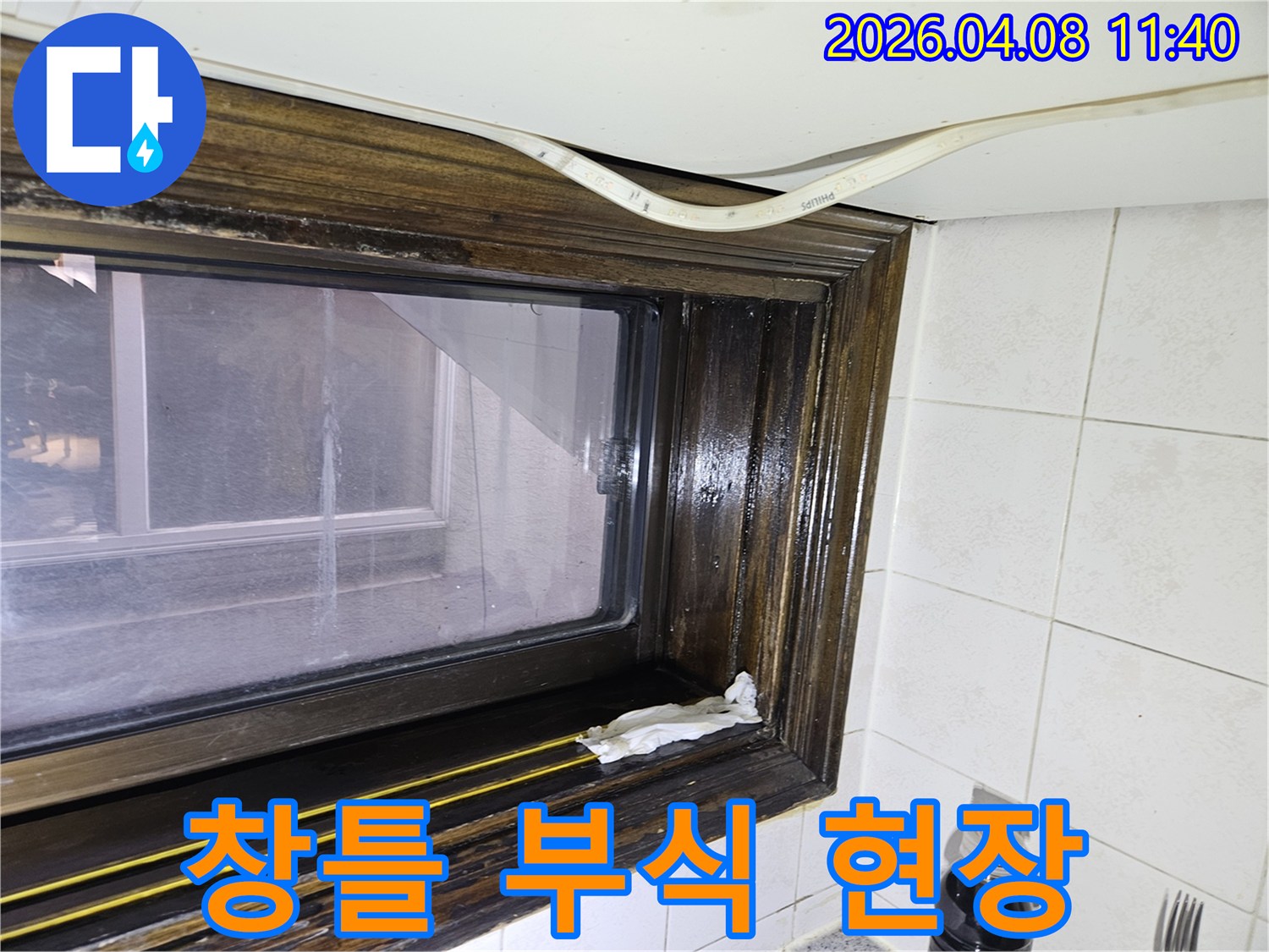 오래된 샷시 틈새로 물기가 스며들어-창틀에 물자국이 생긴 모습을-누수 전문가가 상세히 설명하고 있습니다.