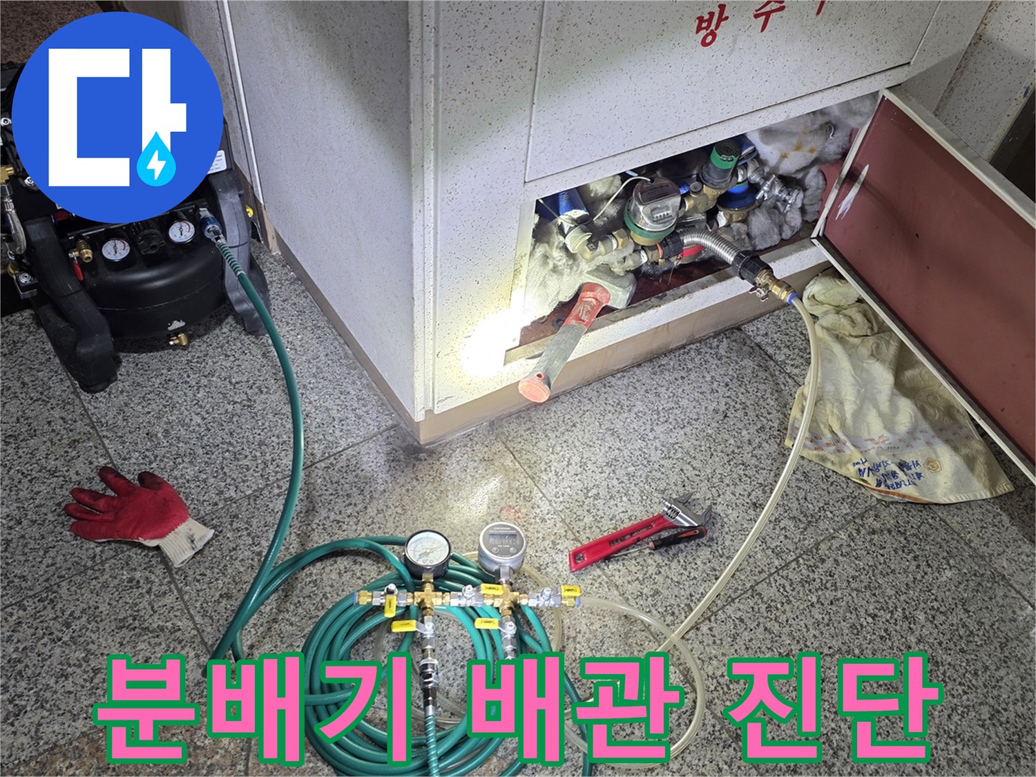 싱크대 하부장 내부 분배기 라인에 압력 게이지와 호스를 연결한 모습