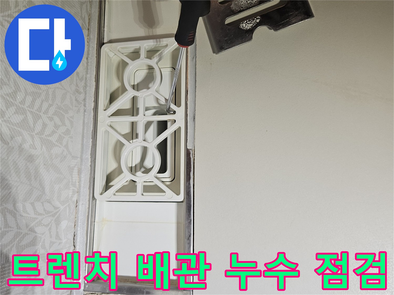 누수-엔지니어가-욕실-트렌치-덮개를-열고-내부-배관의-상태를-점검하는-모습
