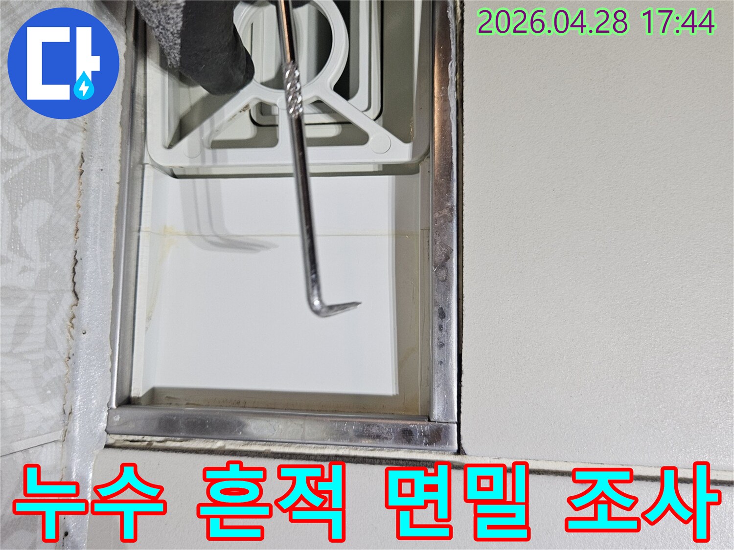 누수 전문가가-특수 도구를 사용하여-주택 벽면의-누수 흔적을-면밀히-조사하는 장면입니다