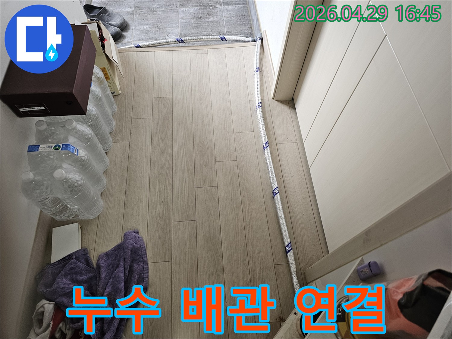 누수 공사 중 바닥에 설치된 보온 배관의 모습-임시 연결된 급수관 작업 현장