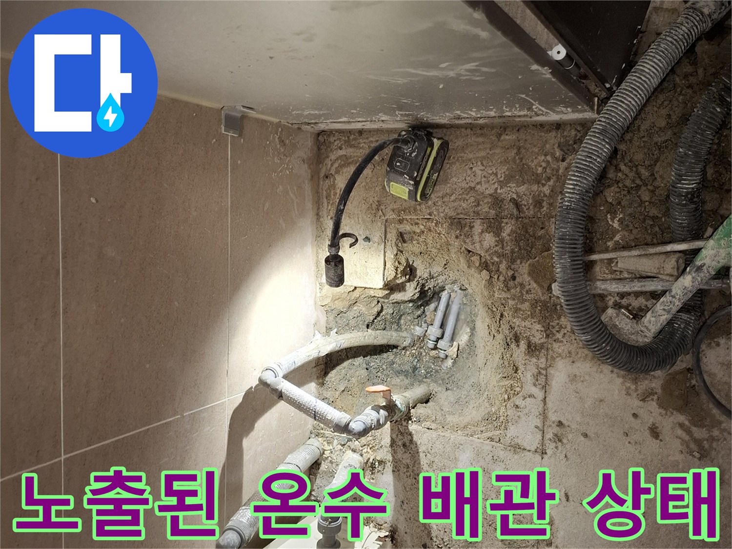 굴착된 바닥의 배관-누수가 발생한 온수 배관의 파손 부위가 드러나 있습니다.