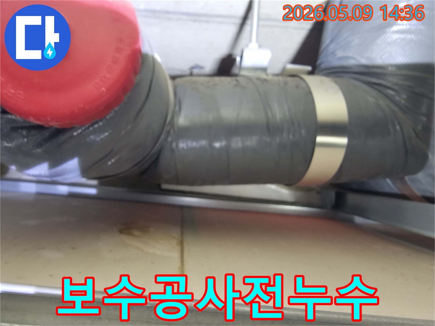 회색-배관-아래-물기가-고여있는-모습을-담은-보수-공사-시작-전-현장-사진입니다