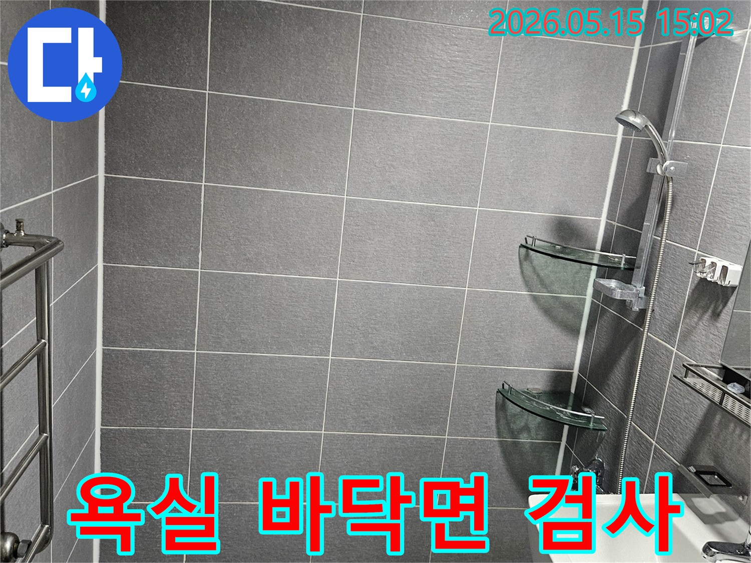 학동 아파트 욕실에서-누수 탐지를 위해-전문가가 방문하여-바닥 타일의-전체적인 면을-꼼꼼하게 검사하는-현장 사진