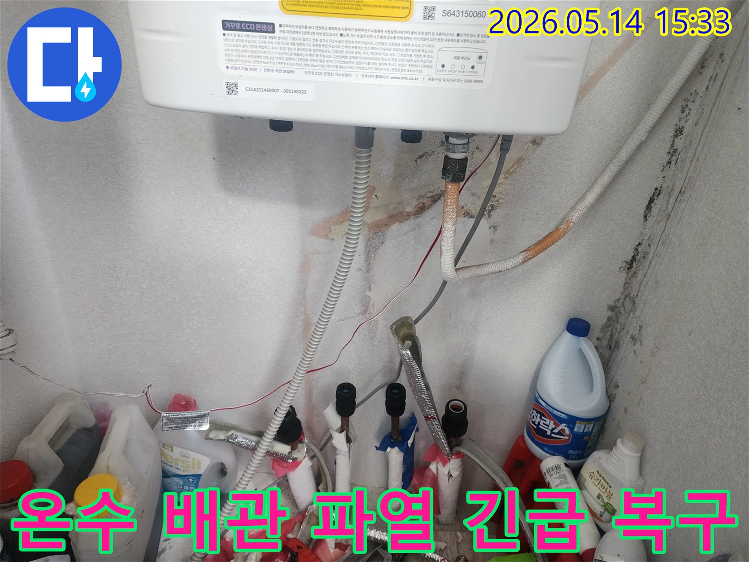 온수 배관 파열로 인한-심각한 누수 흔적과-오염된 벽면을 보여주는-긴급 복구 현장입니다.