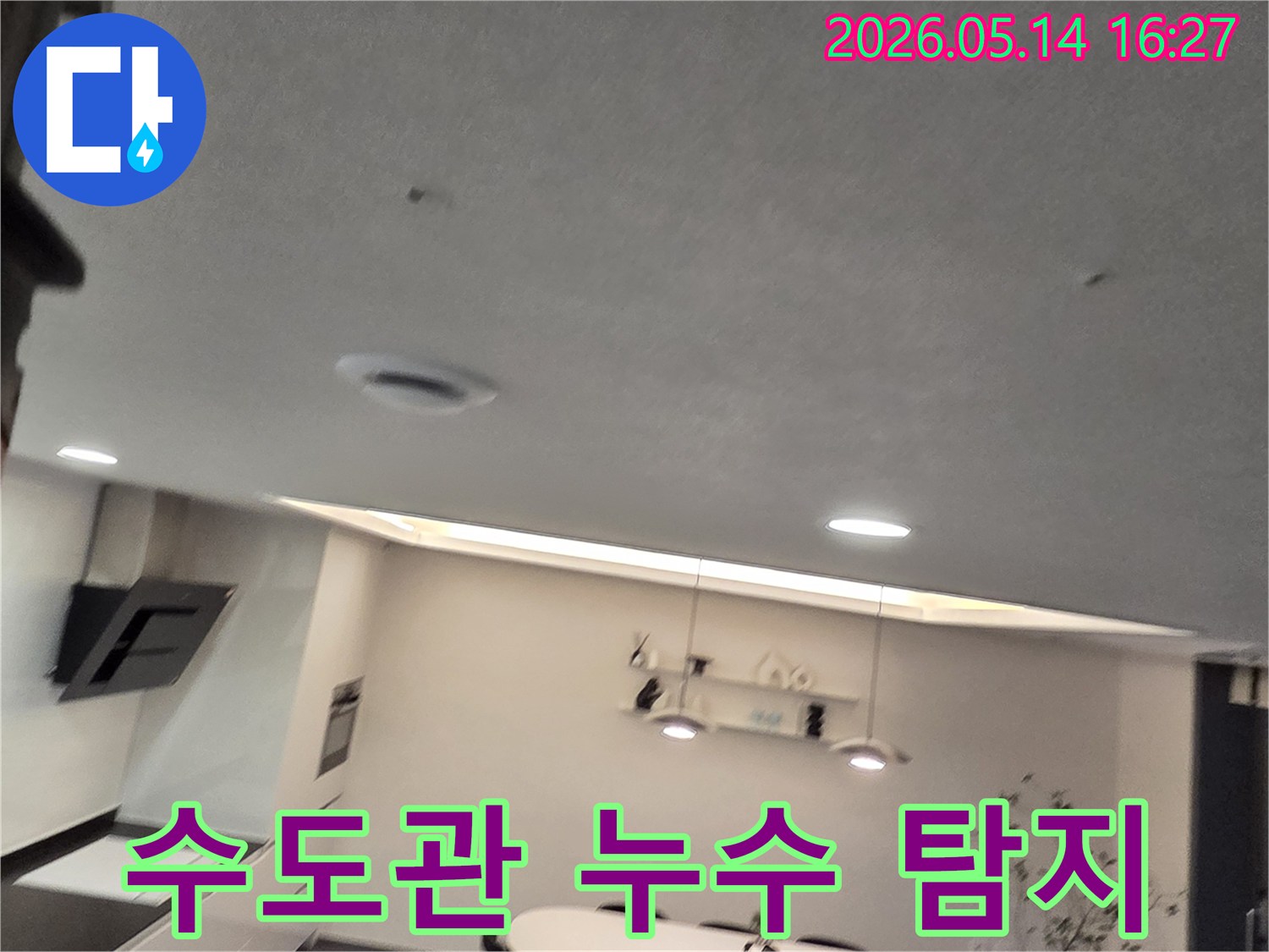 이 이미지는 주방 천장의-작은 물 얼룩과-환기구를 보여주며-수도관 누수 문제의-정밀 탐지와-완벽한 해결의-중요성을 강조합니다