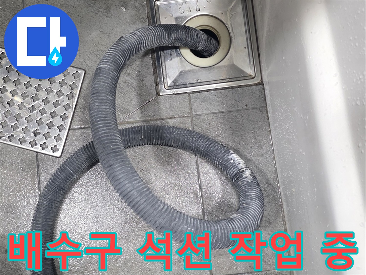 화장실 배수구에 석션 호스를 연결하여 이물질을 흡입하는 모습