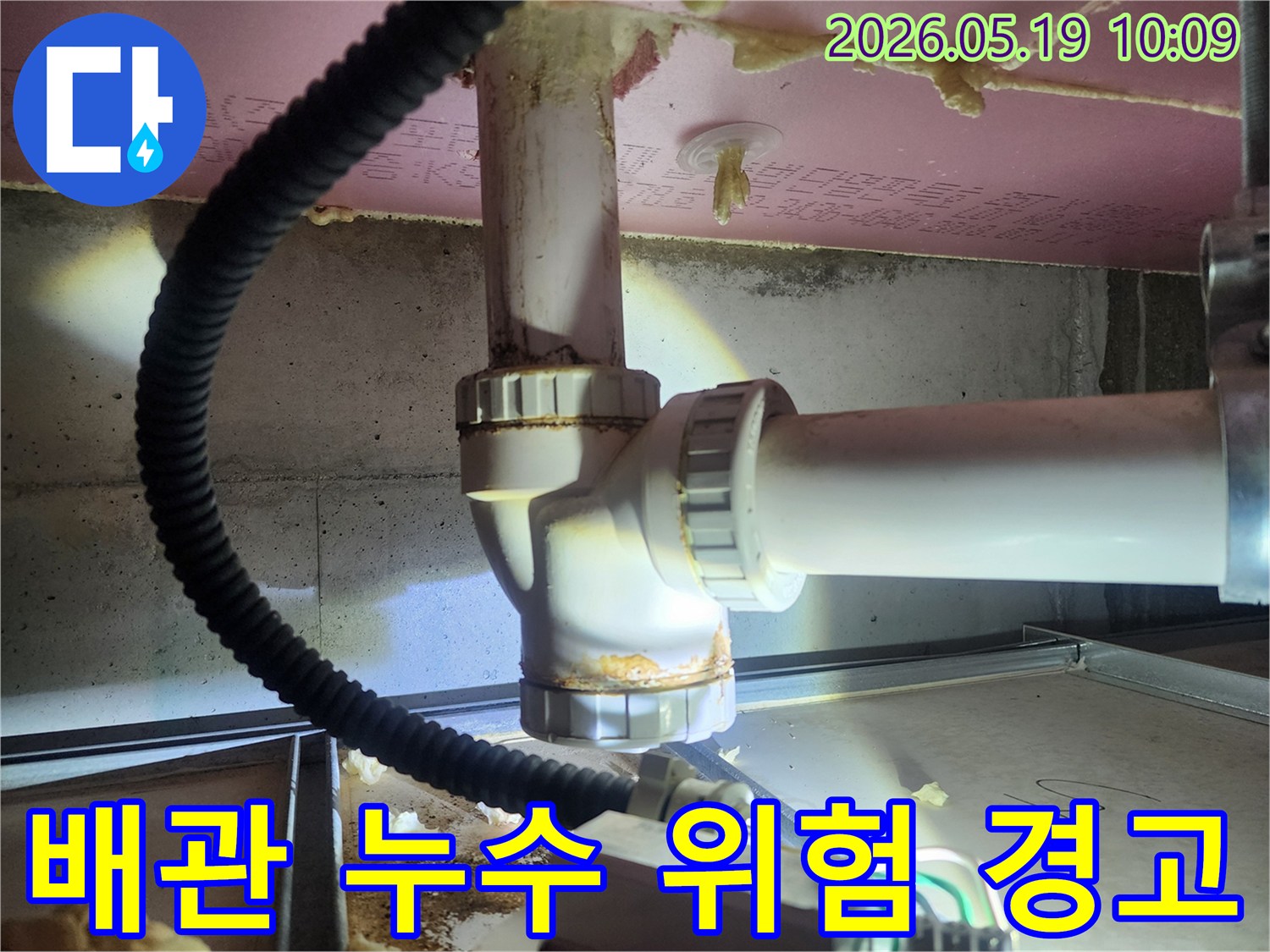 하수관 연결부에서 발견된 물샘 흔적은-지속적인 누수로 인한 부식과 오염을 보여줍니다