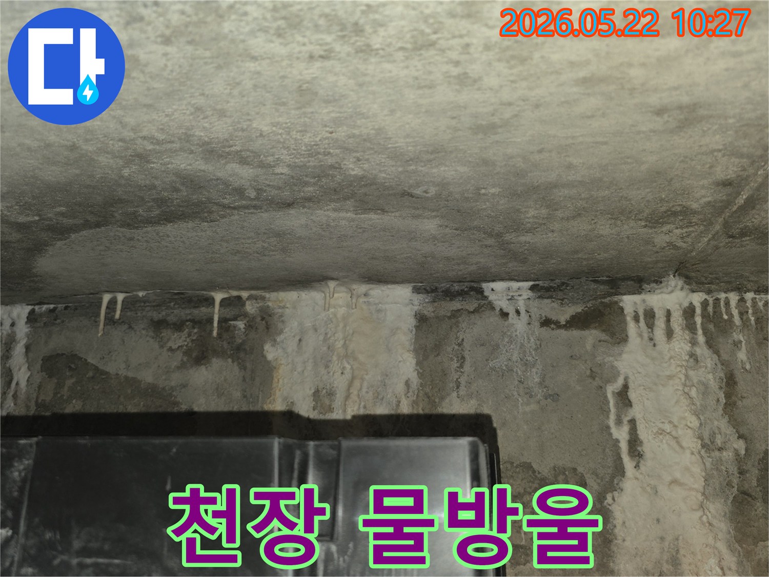 이 이미지는-콘크리트-천장과-벽면-사이에서-발생한-누수로-인해-하얀-석회질이-고드름처럼-맺히고-흘러내리는-모습을-담고-있으며-이는-누수-진단의-필요성을-강조합니다