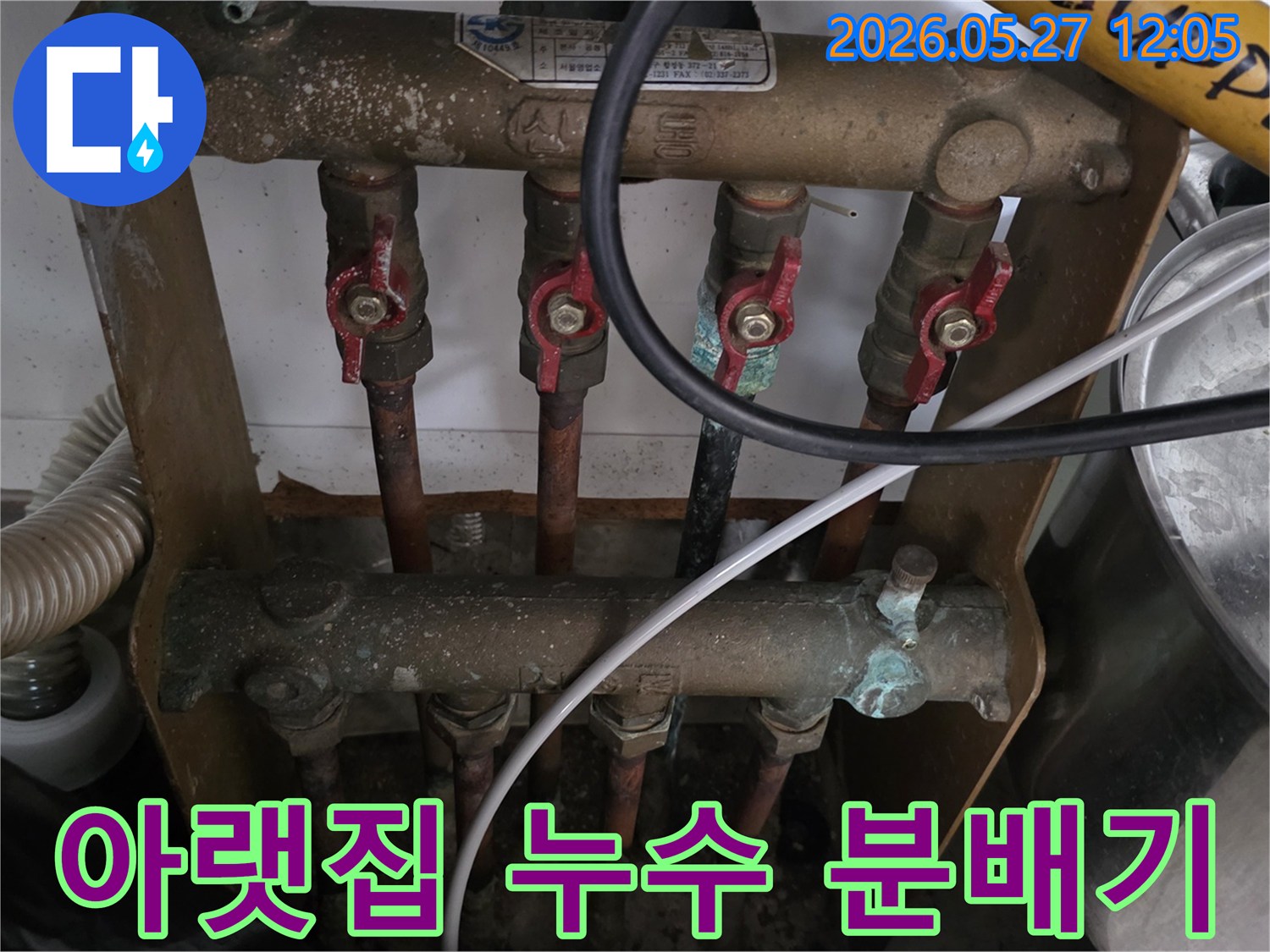아랫집 천장 누수의 원인으로 지목된-오래된 아파트의 보일러 분배기를-전문가가 정밀하게 점검하고 있습니다