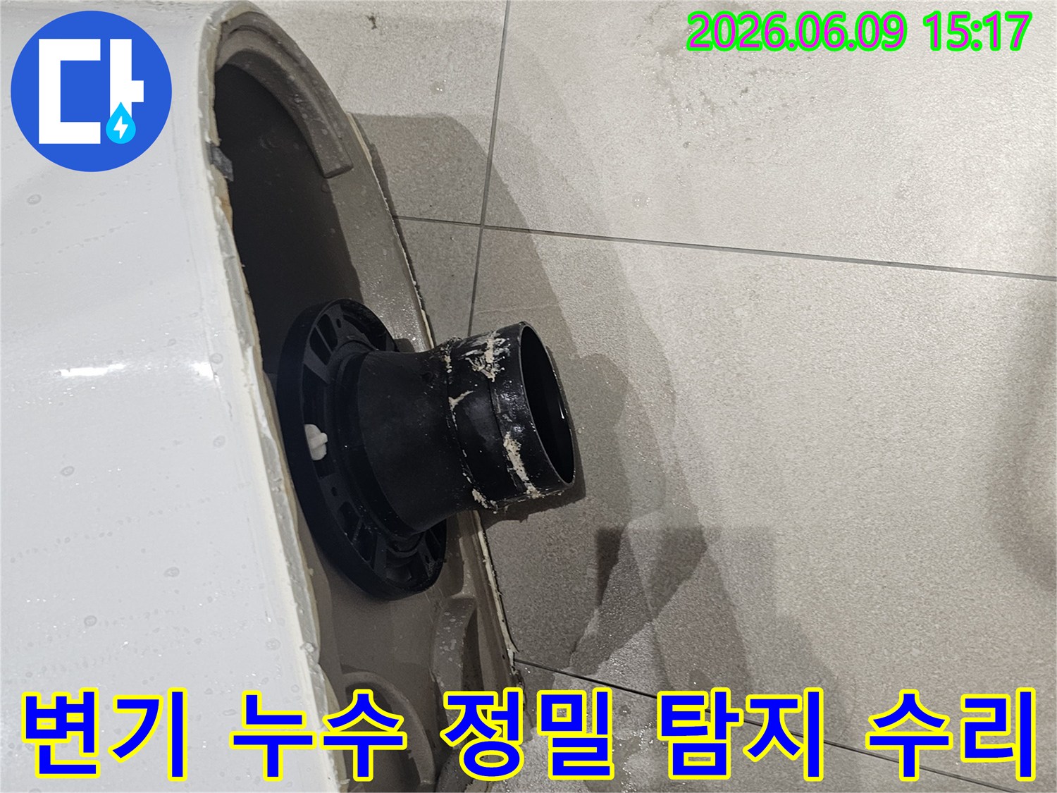 변기가 제거된-욕실 바닥의-오수 배관 주변에-물이 고여있는-모습을 보여주는-누수 현장-사진입니다
