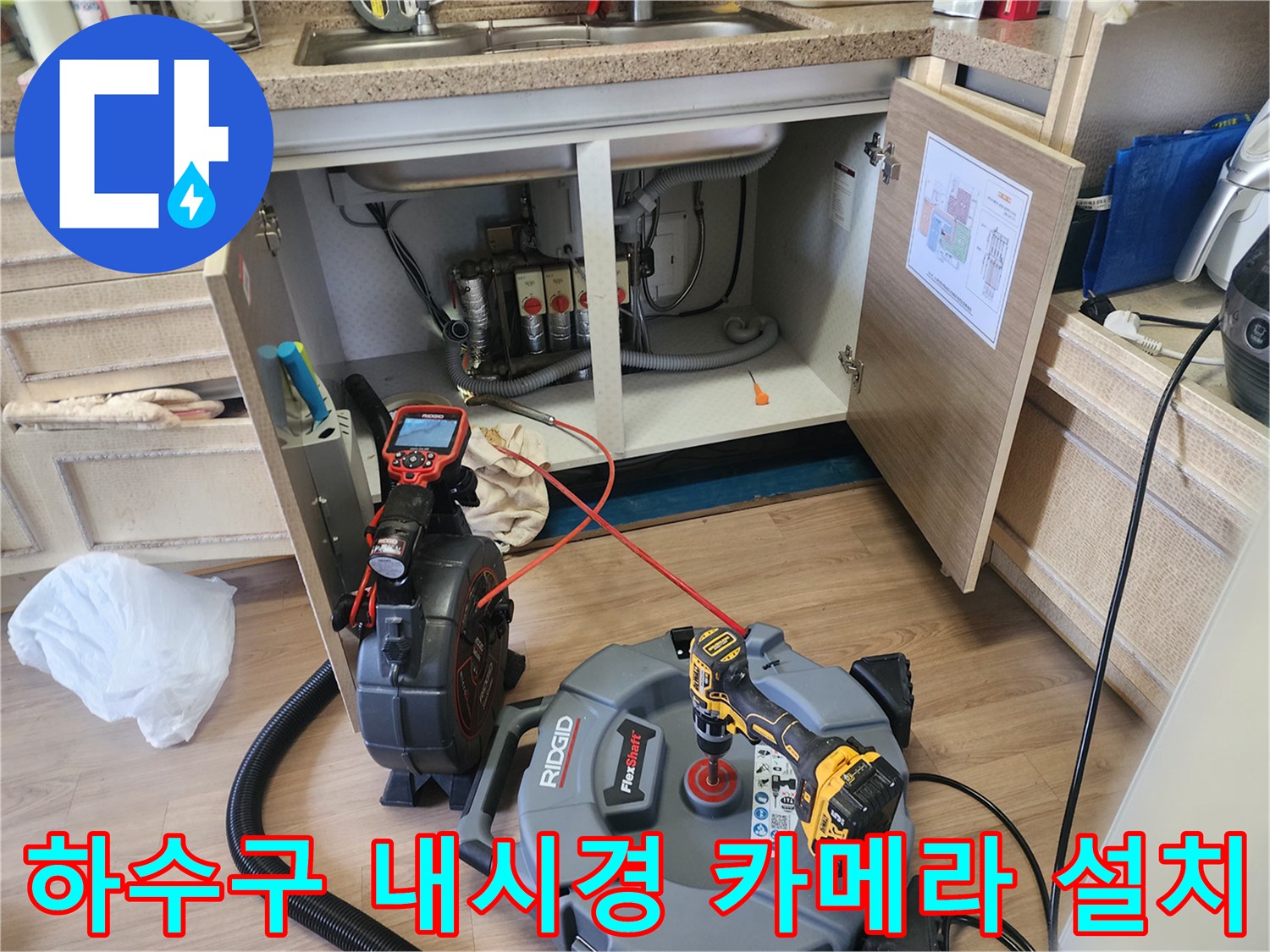 싱크대 아래 배관 내부를 들여다보기 위한 내시경 장비와 전선들