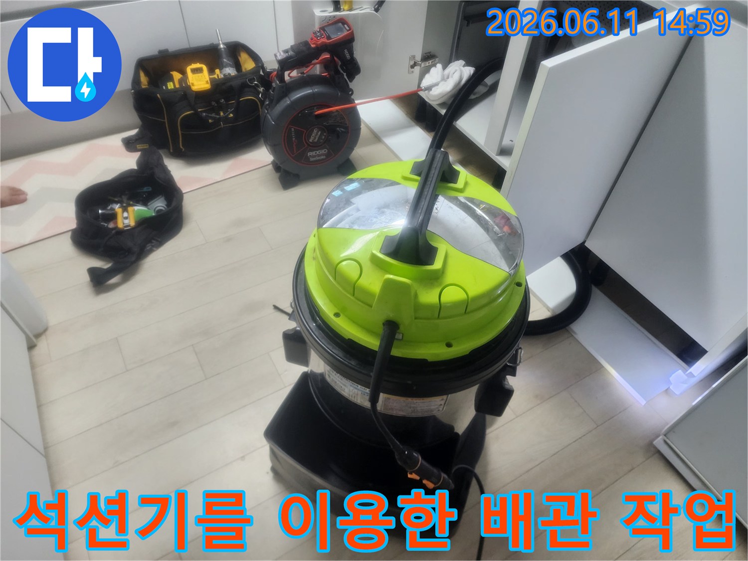 싱크대 하부장 근처에서-배관 이물질을 흡입하기 위해-준비된 석션기 장비