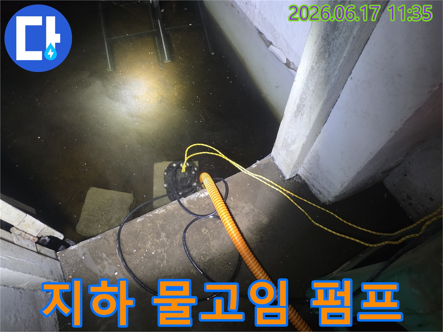 초록마을로의-지하 공간에서-누수 전문가가-배수 펌프를 설치하여-고인 물을 제거하는-작업 현장