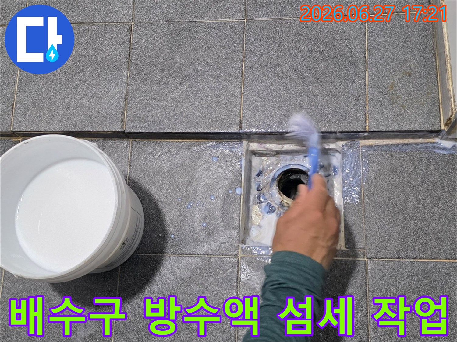 전문 기술자가-욕실 배수구 주변에-방수액을 붓으로 섬세하게 발라-누수를 완벽히 차단하고 있습니다.