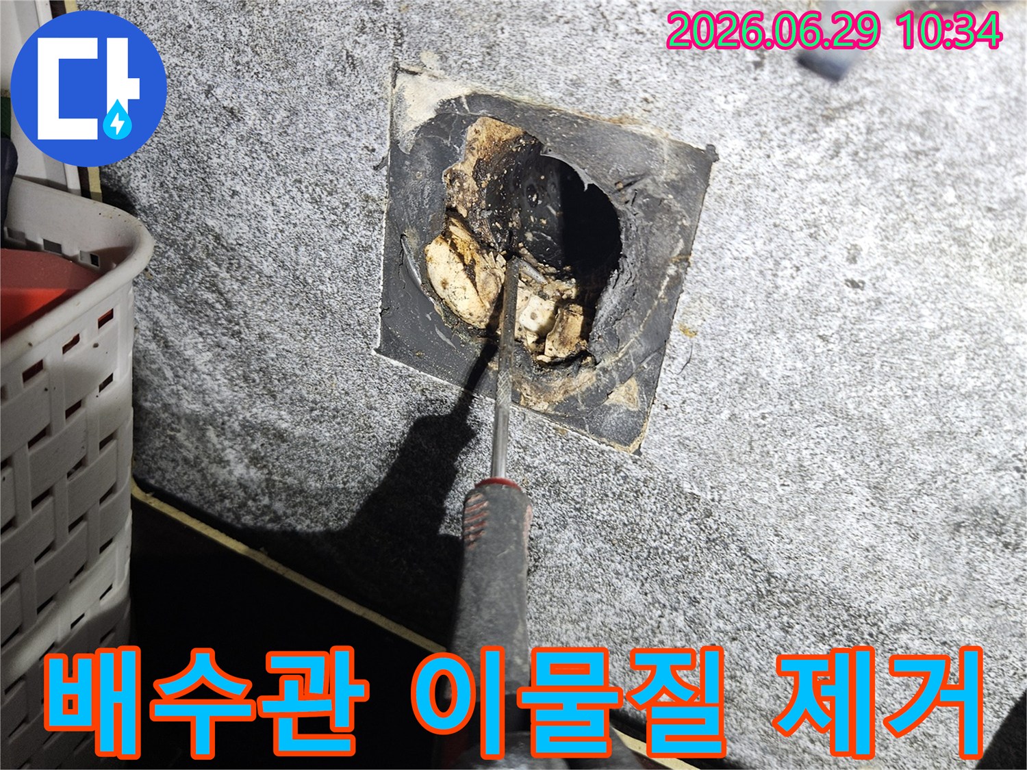 전문가가-중계동 아파트 베란다의-막힌 배수관에서-이물질을 제거하는 작업