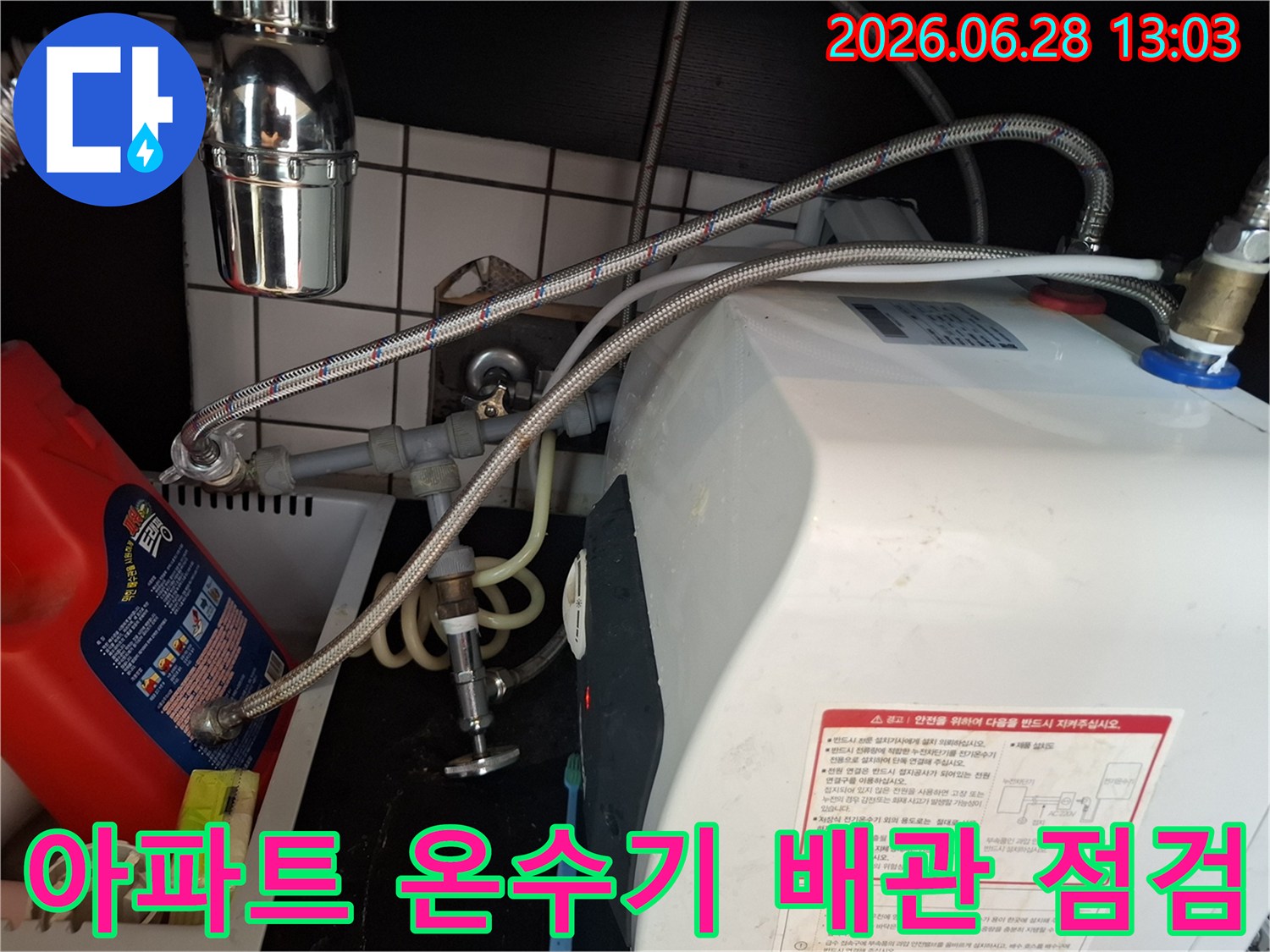 아파트-내부-온수기-배관의-연결-상태를-전문가가-정밀하게-점검하는-과정을-보여줍니다.
