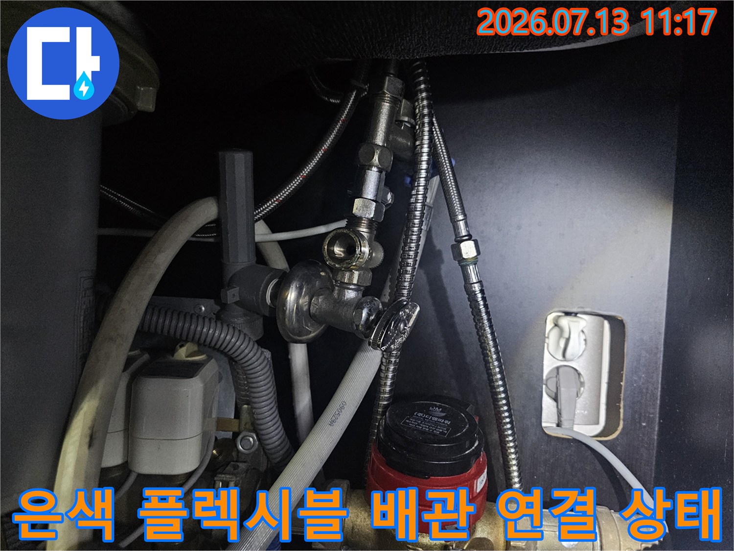 금속제 유연 호스가 보일러 하단 밸브에 체결된 모습-근접 사진