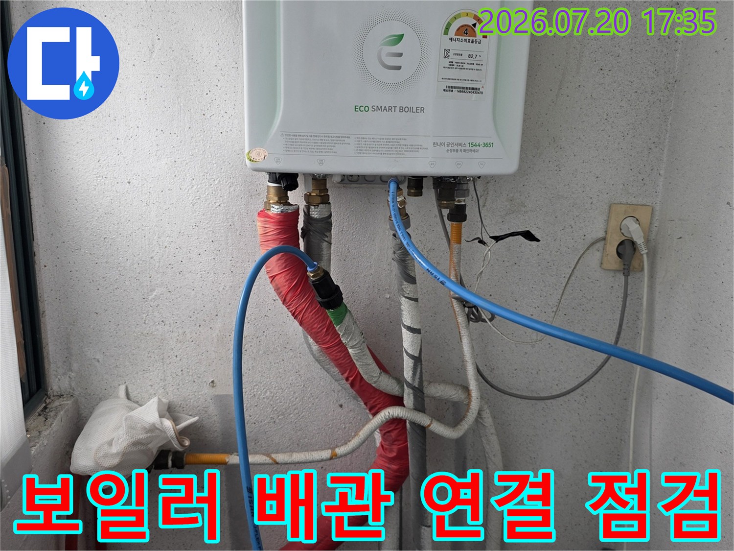 보일러 본체 아래에 연결된 빨간색과 파란색 보온재가 씌워진 배관 시스템