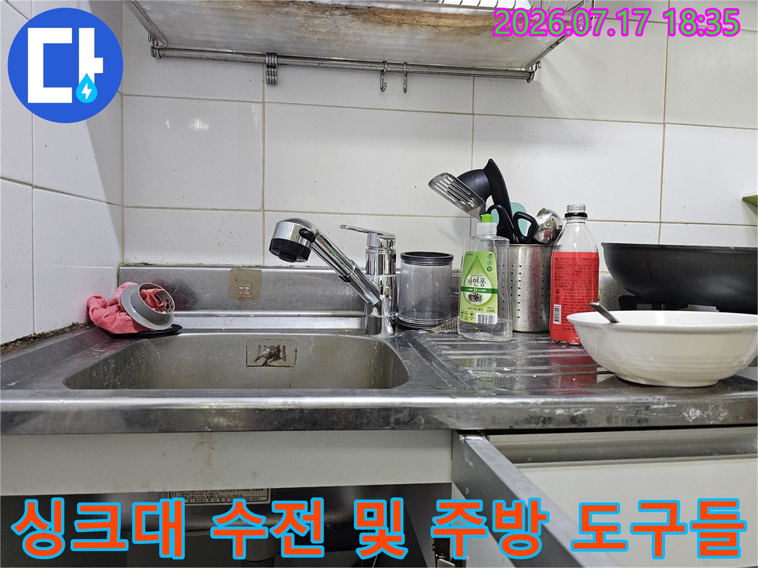 주방 싱크대에 놓인 세정제-거위목 모양의 수도꼭지와 스테인리스 볼