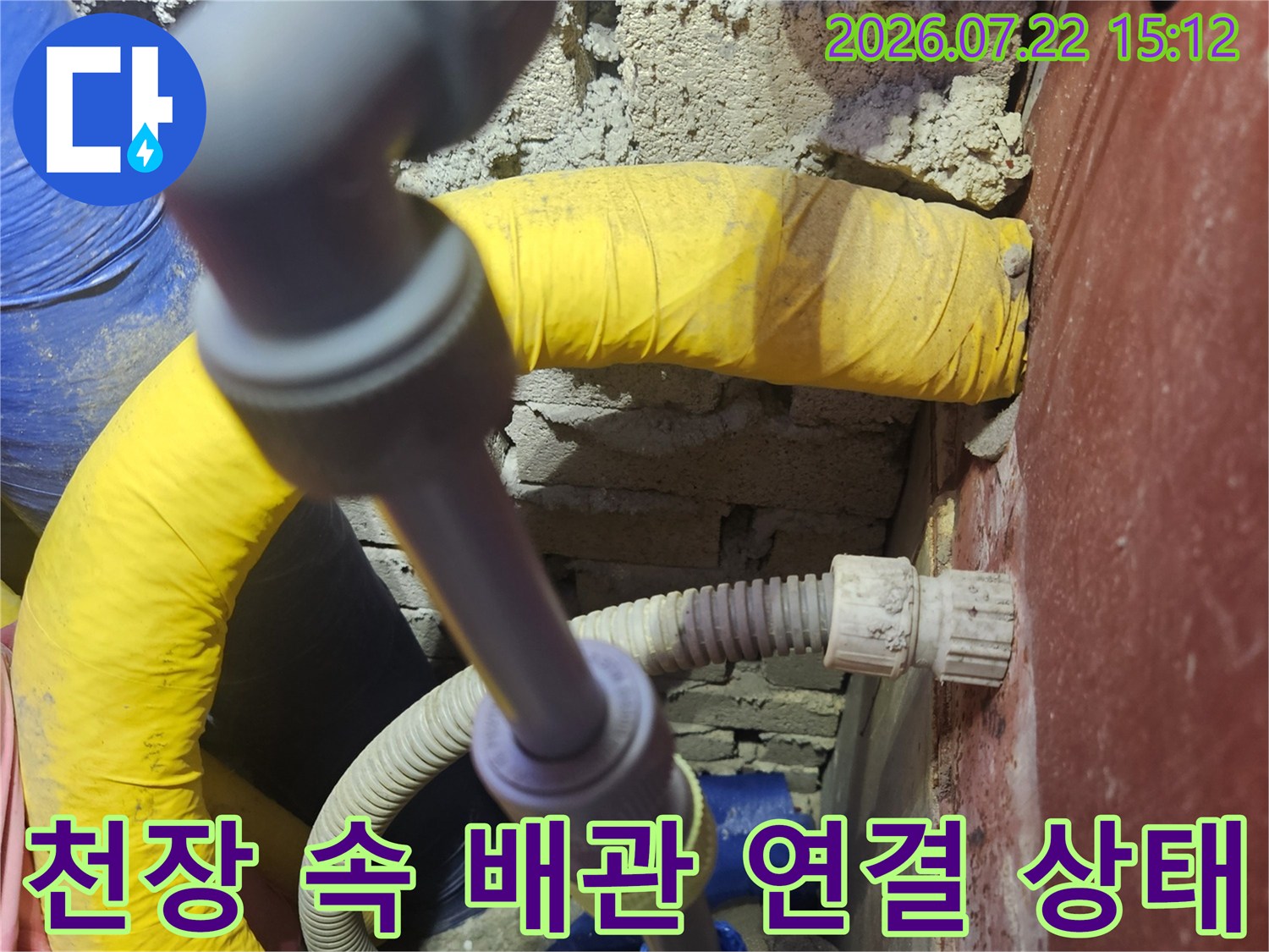 노란색 단열재가 입혀진 관과 회색 플라스틱 수도관이 교차 설치된 모습