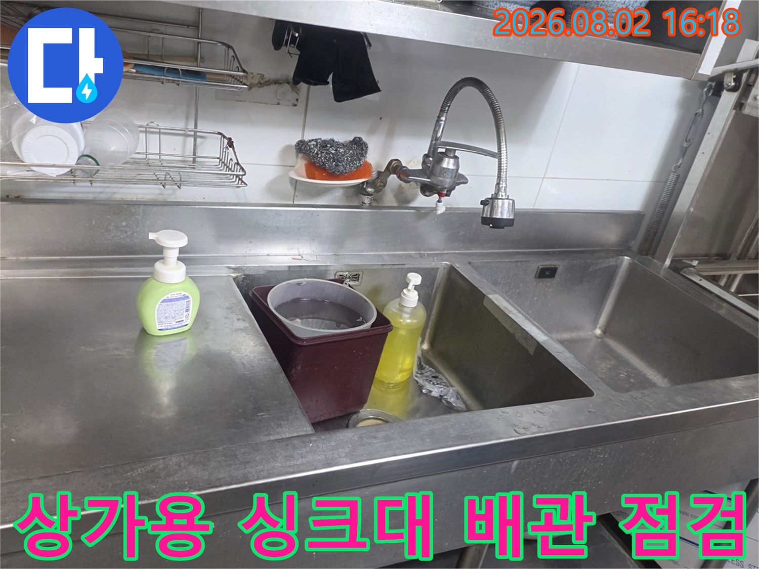 금속 소재의 상업용 주방 싱크대와 수전이 설치된 모습