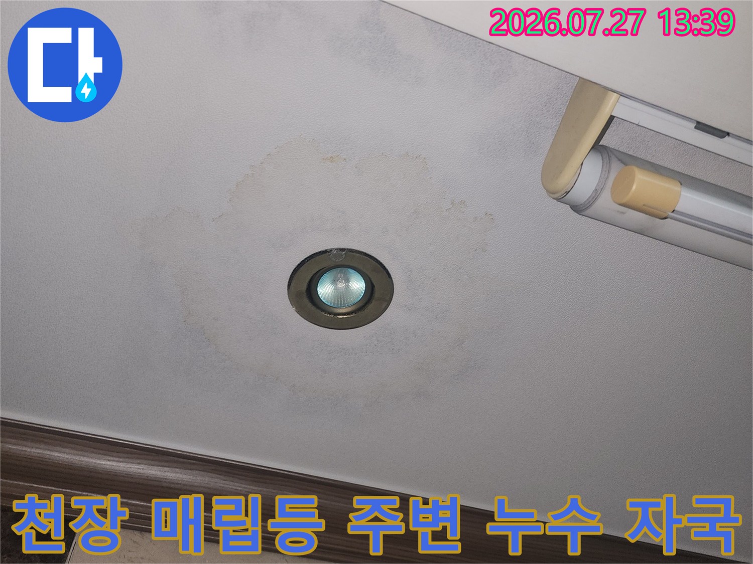 흰색 거실 천장의 조명 주변에 동그랗게 형성된 누수 변색-사진