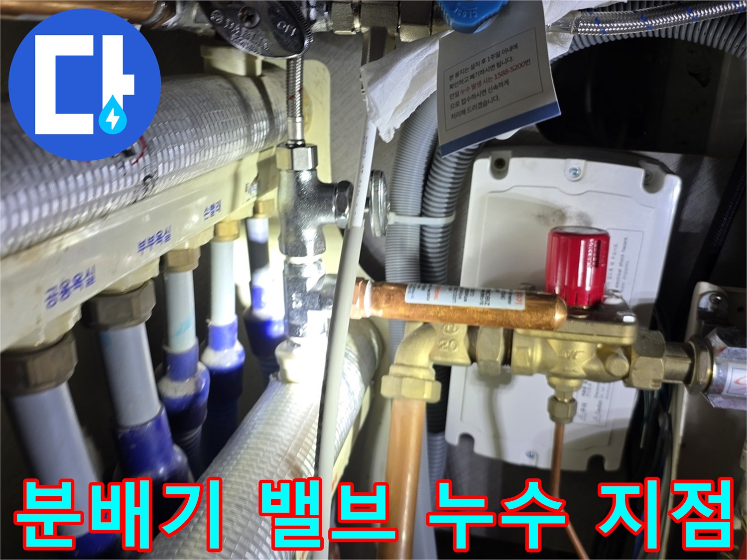 싱크대 하단 분배기의 온수 밸브와 연결 배관 근접 촬영
