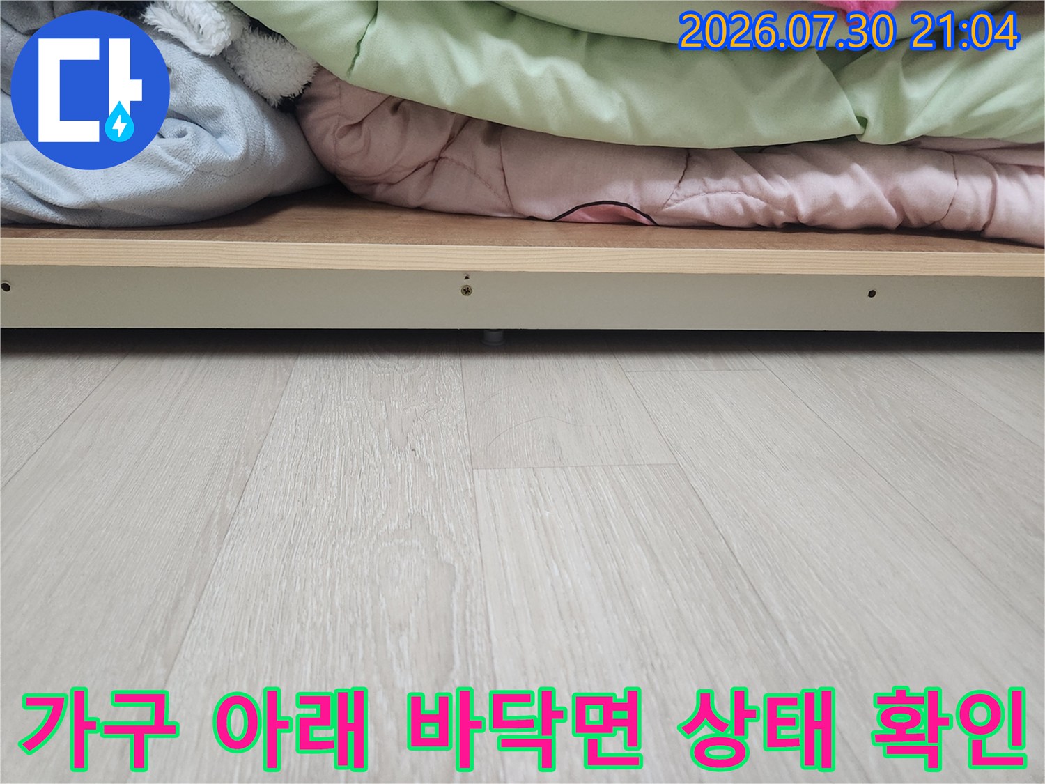 장롱 밑바닥 마감재와 수분 침투 여부를 점검하는 누수 탐지 공사 장면