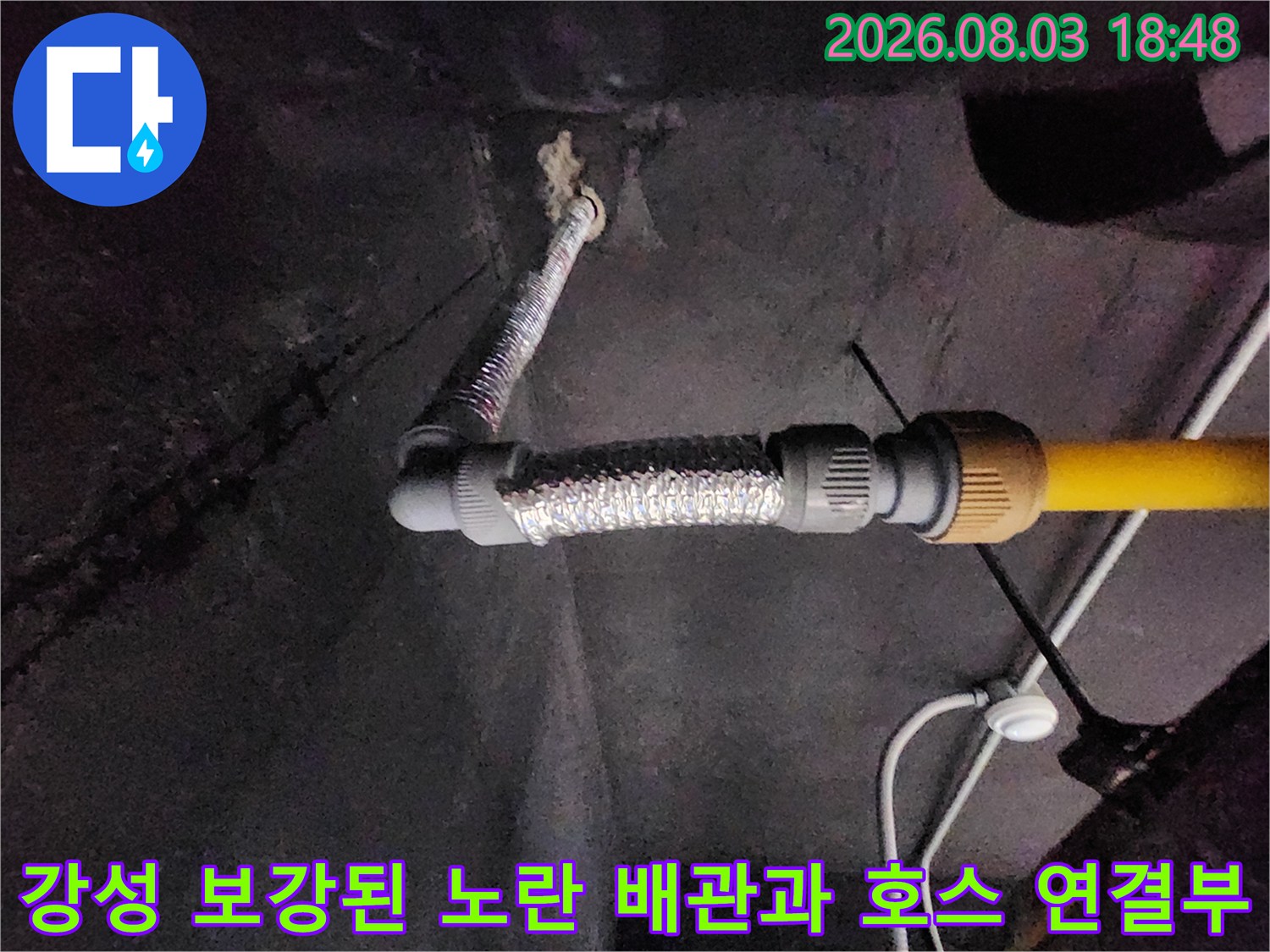 노란색 파이프와 은색 보호용 유연호스가 맞물린 구간의 근접 촬영