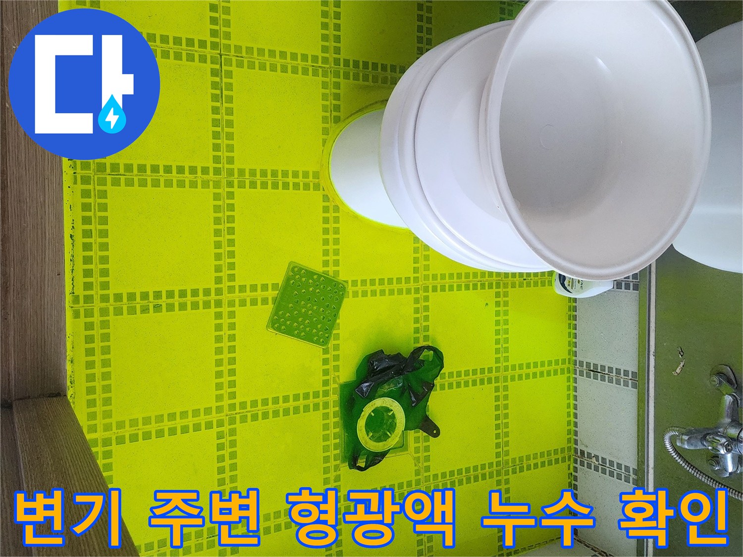 변기 근처 타일에 형광색 물이 스며드는 것을 통해 누수를 진단하는 과정입니다.