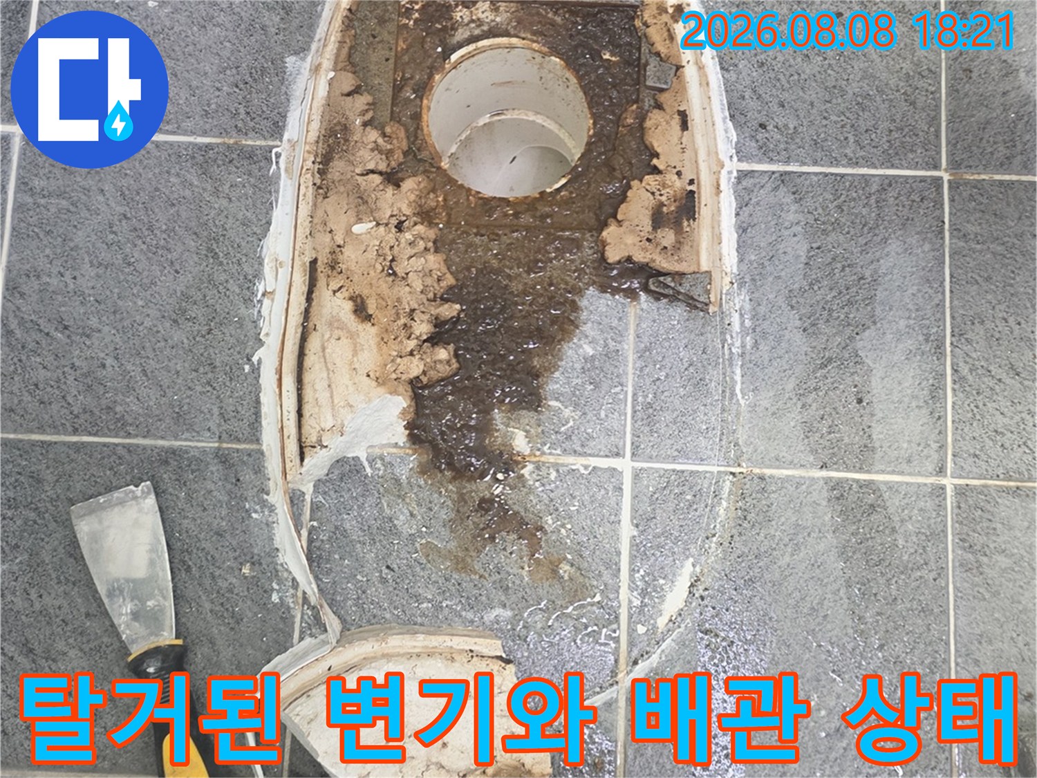 변기를 탈거한 후 드러난 오염된 배관 주변과 깨진 타일 모습