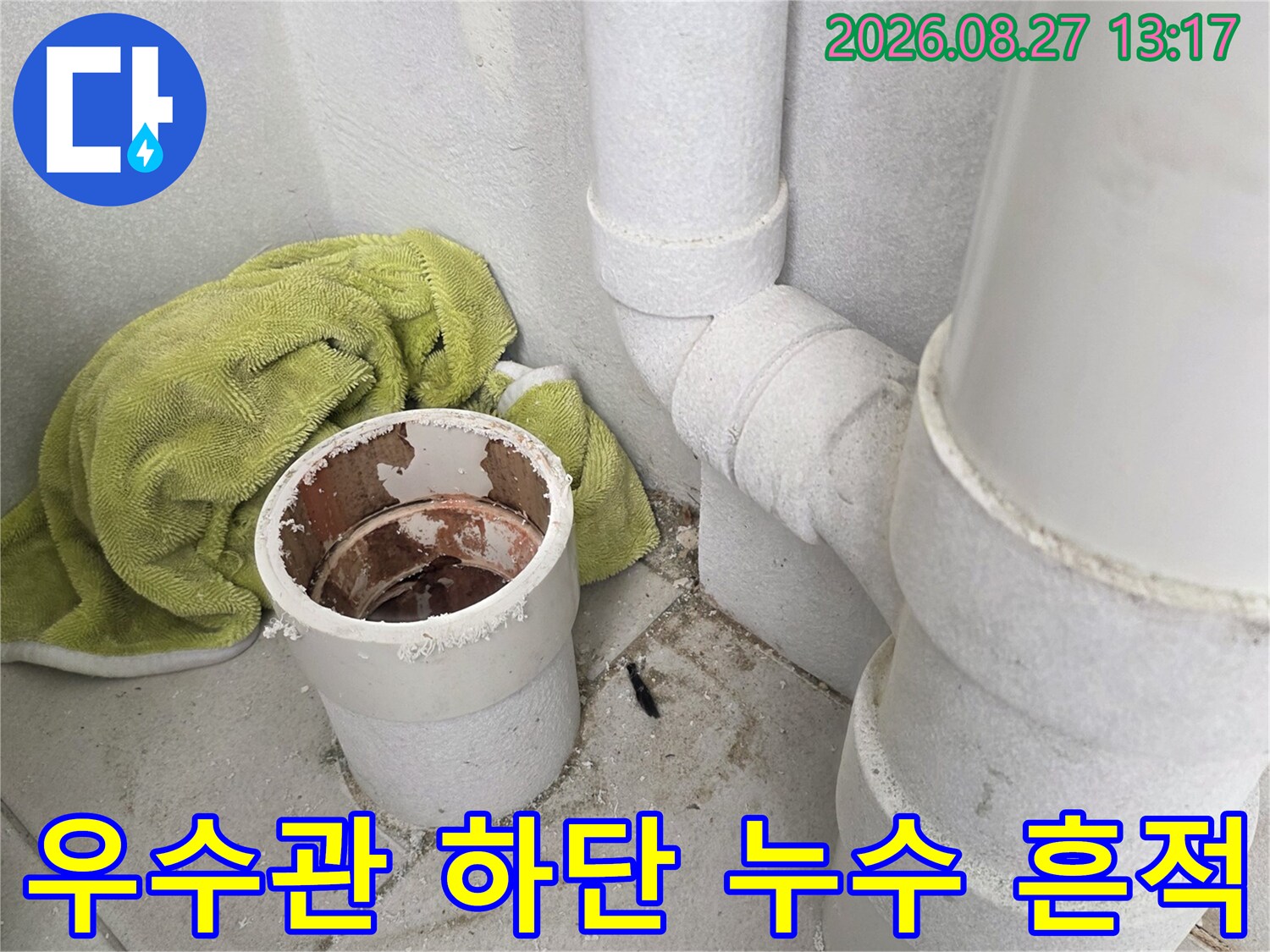 우수관 배관 주변 바닥재와 연결 부위의 습기 상태를 보여줍니다.