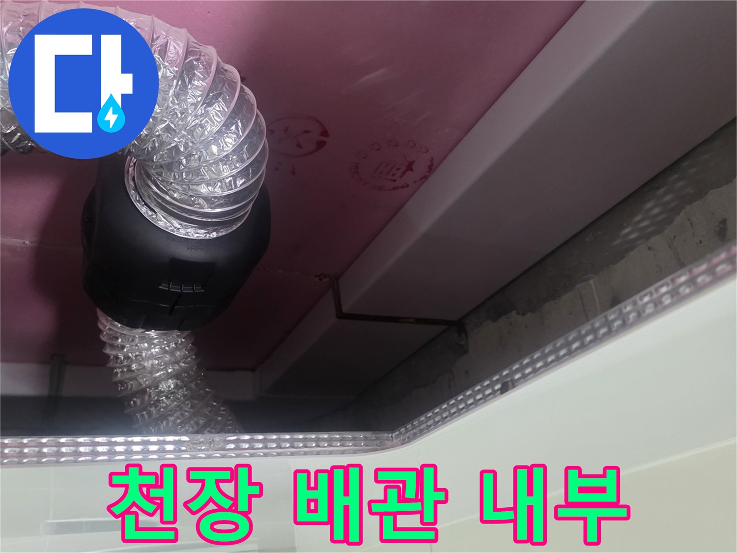 천장 마감재 사이로 보이는 환기 호스와 배관 연결 부위