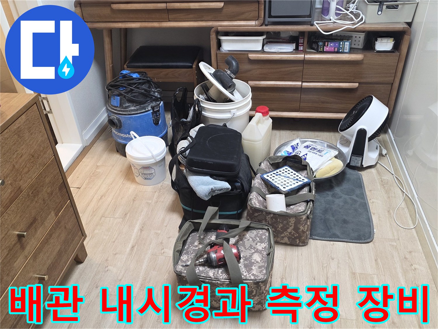 욕실 누수 부위를 확인하기 위해 거실 한쪽에 준비된 배관 내시로 및 진단 도구들