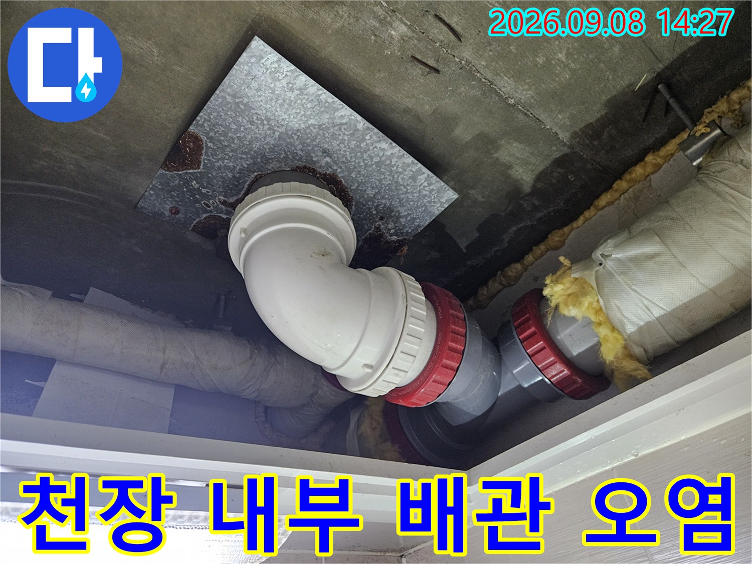 욕실 천장 점검구 안쪽의 하얀색 배관과 주변 금속판에 나타난 누수 흔적을 상세히 촬영하였습니다.