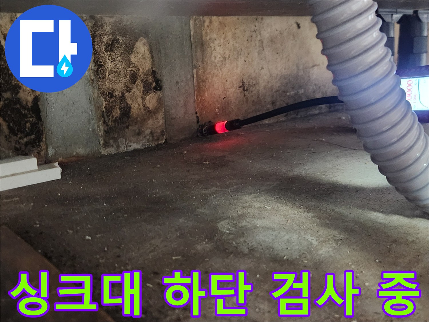 하얀색 유연한 호스와 탐지 장비로 싱크대 밑 배관 누수를 찾는 과정