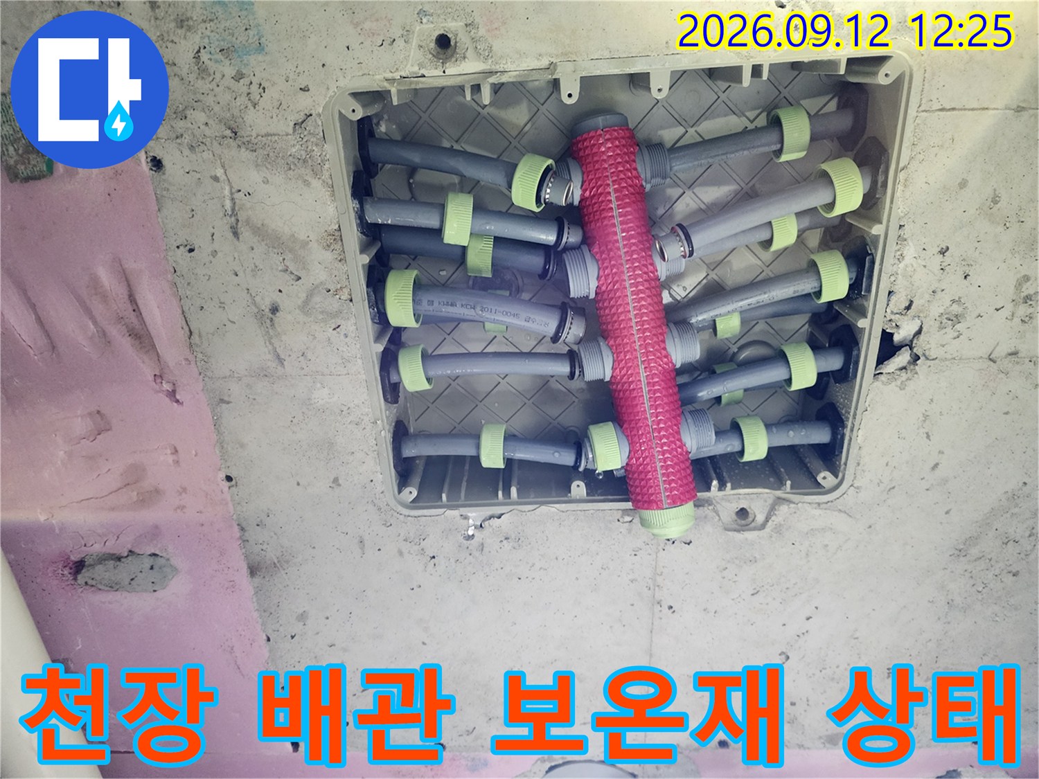 보온재로 감싸진 배관과 연결된 여러 수도 라인의 모습입니다.